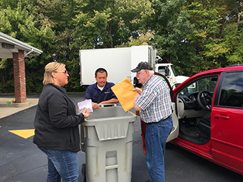 assisting members with shredding